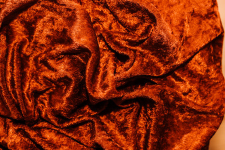 Texture of red velor corduroy fabric with folds.の写真素材