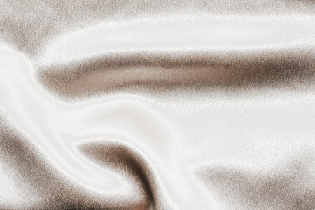 Golden shiny texture of silk satin satin with folds.の写真素材
