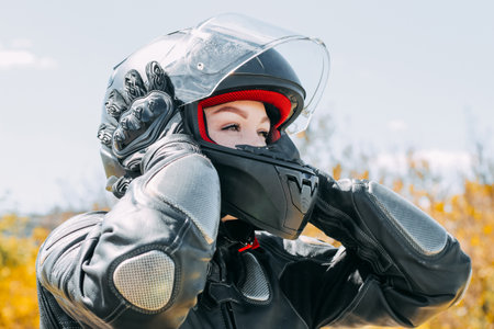 A girl in a motorcycle protective helmet close-upの写真素材
