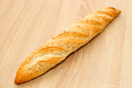 Fresh baguette made of white wheat flour with seeds and cereals.の写真素材