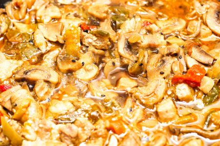 Vegetable stew with champignons and sesame close-up.の写真素材
