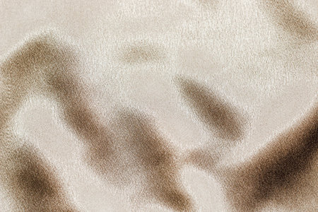 Golden shiny texture of silk satin satin with folds.の写真素材
