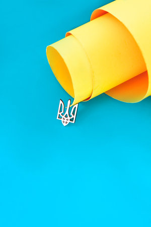 Trident symbol of Ukraine iron badge on the background of the blue-yellow flagの写真素材
