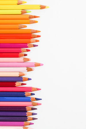 Colored pencils lie on a white table.の写真素材