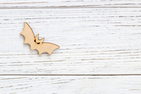 Wooden bat toy on a wooden background, Halloween conceptの写真素材