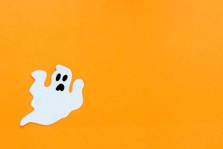 Paper ghosts on an orange background, Halloween conceptの写真素材