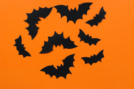 Paper bats on an orange background, Halloween conceptの写真素材