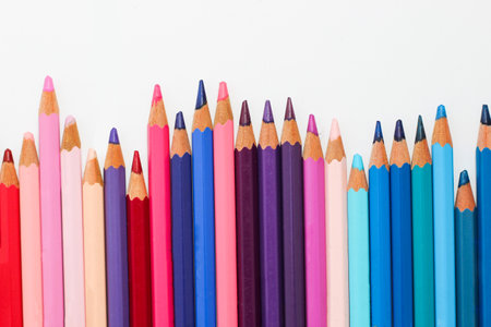 Multi-colored pencils lie on a white table, the violet range of colors.の写真素材