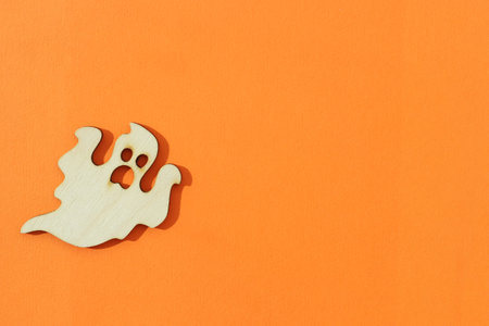 Wooden ghost toy on an orange background, Halloween conceptの写真素材