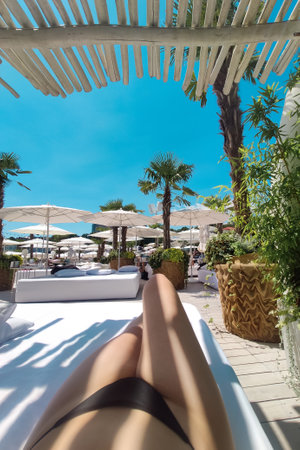 Selfie of a woman on vacation under a sun umbrellaの写真素材