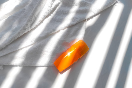Spray sunscreen on a background of shadows