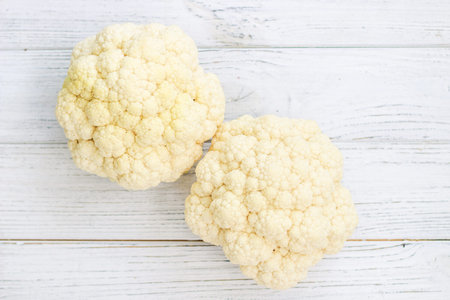 Cauliflower vegetables standing on a white wooden tableの写真素材