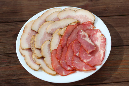 Sliced pieces of spicy lard and meat on a plate