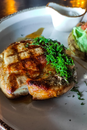 A dish of pork medallion with dill close-up with sauceの写真素材