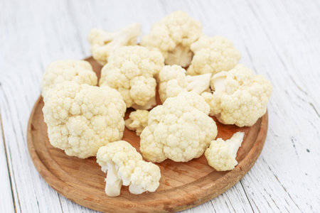 Cauliflower vegetables standing on a white wooden tableの写真素材