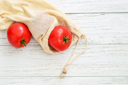 Reusable eco bags for shopping with tomato, replacing plastic bagsの写真素材