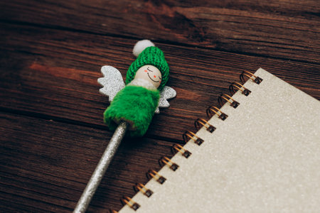 writing pen decorated with a Christmas snowman with a notebookの写真素材