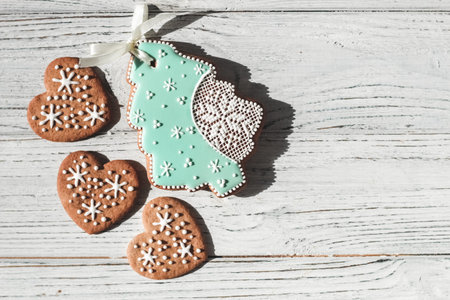 Homemade cookies in the shape of hearts and gingerbread in the shape of a Christmas tree with...