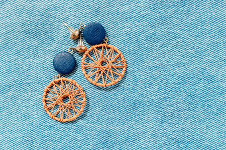 earrings accessories on denim texture