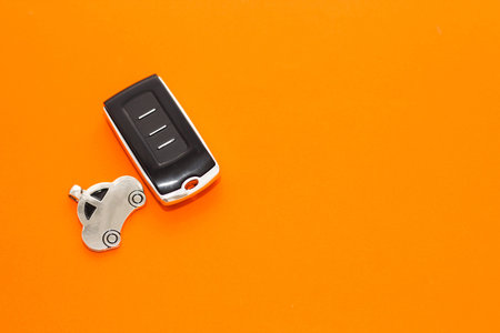 car keys, remote control on an orange background
