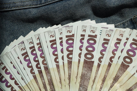 Banknote of 1000 Ukrainian hryvnias on a denim background in a pocket