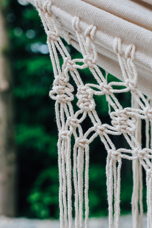 Close-up view of natural fibers intricately woven capturing the beauty of craftsmanship amidst greenery.の写真素材
