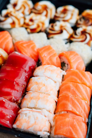 A delightful assortment of sushi features various rolls and sashimi showcasing fresh fish and vibrant colors.の写真素材