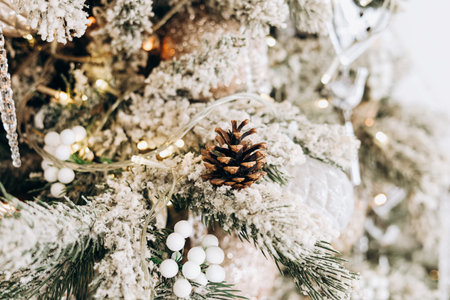 A beautifully decorated pine tree adorned with snow-like elements white ornaments and twinkling...