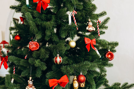 A decorated Christmas tree with red bows colorful ornaments and candy canes creates a festive holiday atmosphere.の写真素材