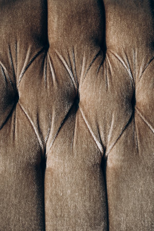 Detailed observation of a tufted upholstery fabric highlighting texture and pattern variations. The close-up captures the intricate design elements.の写真素材