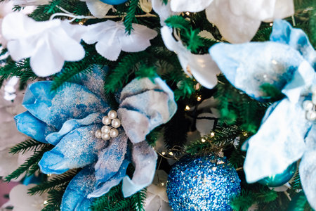 Colorful blue flowers and ornaments create a cheerful atmosphere for holiday celebrations. Detailed decorations showcase craftsmanship and creativity.の写真素材