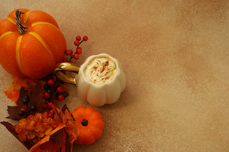 Pumpkin Spice Latte orange pumpkin and seasonal leaves with a small dessert that has swirls of...