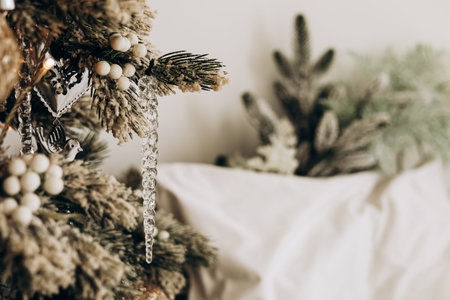 A beautifully decorated Christmas tree adorned with frosted branches and shimmering ornaments stands...