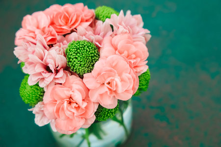 A lovely arrangement features bunches of pink flowers alongside bright green accents. The flowers...