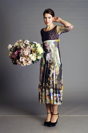 woman with a bouquet, big bouquet, coat, fashionable coat, bright coat, autumn women's coat, women's coat, light overcoatの写真素材