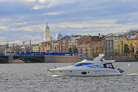 Saint Petersburg, RUSSIA - MAY 06, 2017: Motor yacht against the backdrop of historical buildings and the Prince Vladimir Cathedralのeditorial素材