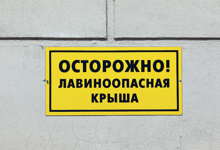 The table with an inscription in Russian "Carefully. Avalanche roof"の写真素材