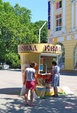Novorossiysk, RUSSIA-AUGUST 10, 2015: woman buys Russian national drink kvass on a hot dayのeditorial素材