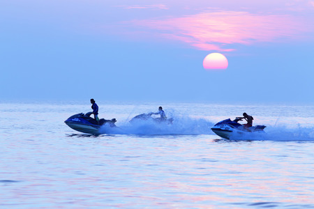 PATTAYA, THAILAND-JANUARY 02, 2014: Tourist riding in the sea on a scooter at sunsetのeditorial素材