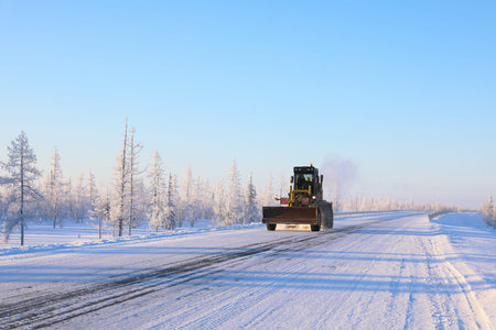 NADYM, RUSSIA-FEBRUARY 06, 2019: road machinery rides on the highway on a frosty dayのeditorial素材