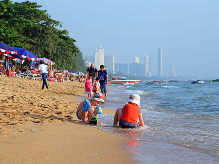 PATTAYA, THAILAND-DECEMBER 26, 2013: Children playing on the beach among the sand and wavesのeditorial素材