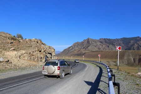 Altai Republic, RUSSIA-MAY 09, 2014: a Passenger car drives along the Federal highway M-52 Chuysky tract in the Altai Mountainsのeditorial素材
