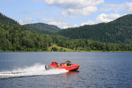 Altai Republic, RUSSIA-JUNE 12, 2007: Boat with tourists on Teletskoye lake in the Altai mountains