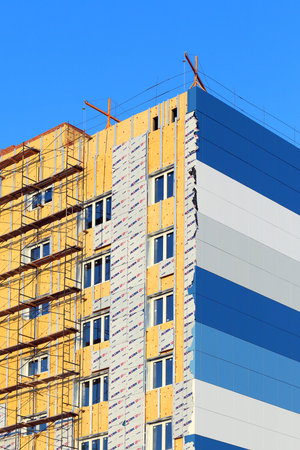 Nadym, Russia-FEBRUARY 28, 2015: thermal Insulation and siding of a high-rise residential building