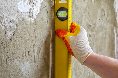 plasterer concrete worker at wall of house constructionの写真素材