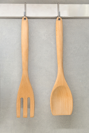 Wooden kitchenware on a brick wallの写真素材