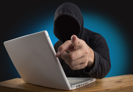 hacker hacking computer network with laptop, Dark face hackerの写真素材