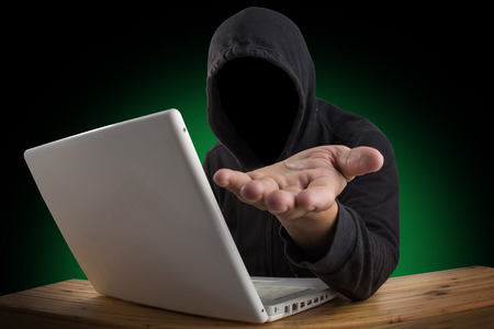hacker hacking computer network with laptop, Dark face hackerの写真素材