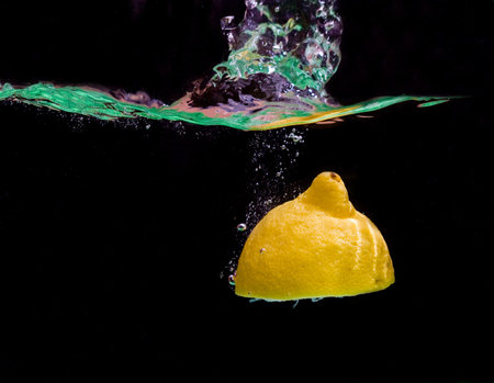 Fresh lemon falls in waterの写真素材