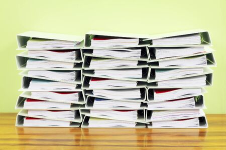 bunch of folders on wood tableの写真素材